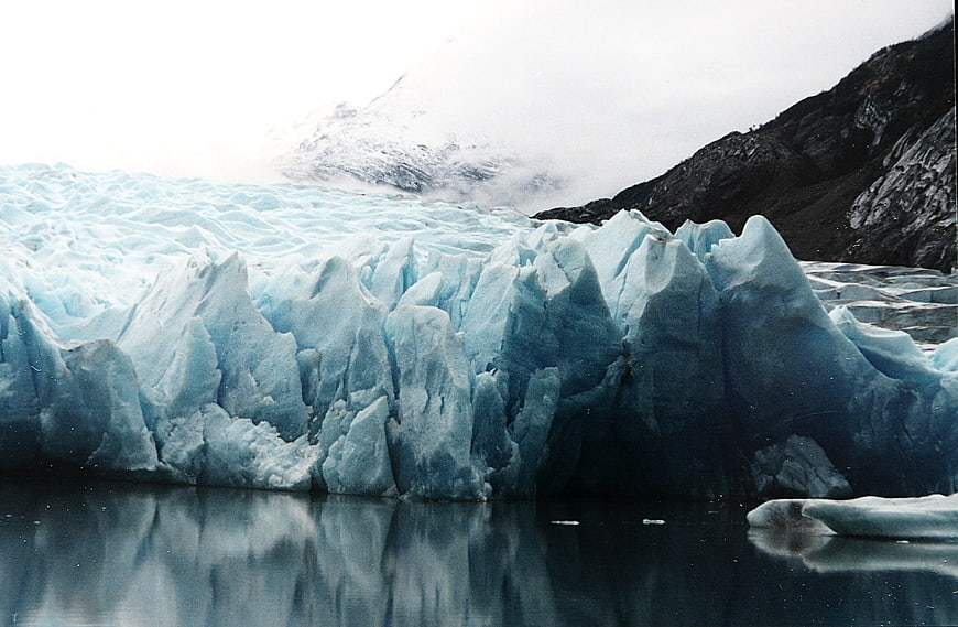Majestic Blue Glacier Face with Mountain Reflection
