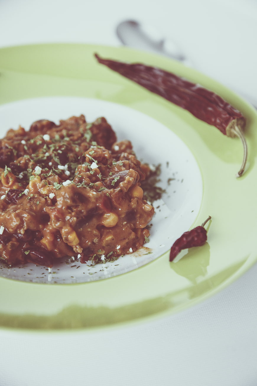 Spicy chili con carne with dried peppers on a plate