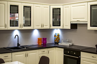 Modern kitchen with white cabinets and black countertops