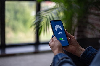 Hands holding smartphone with VPN app interface