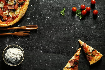 Flat lay pizza with ingredients on dark background