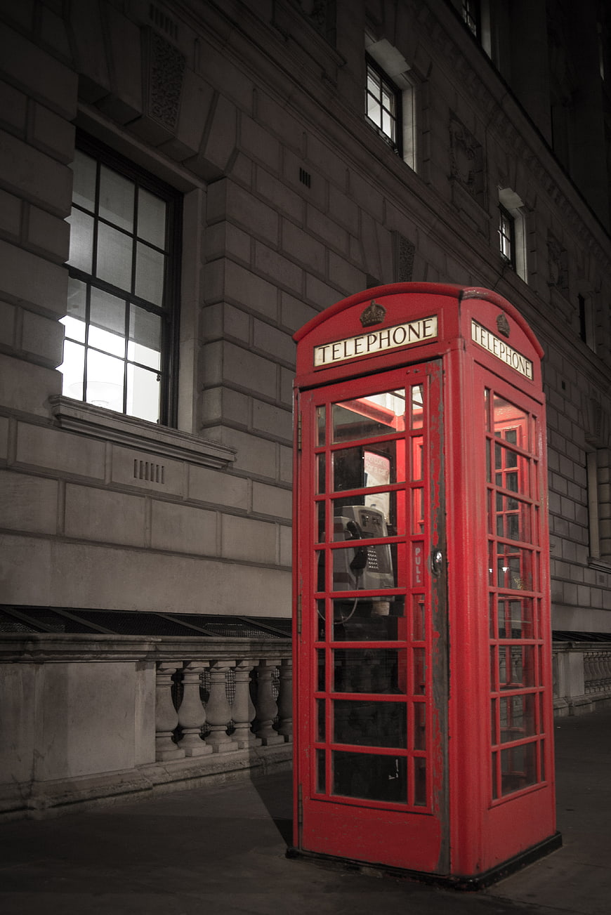 Classic Red Telephone Booth on London Street at Night