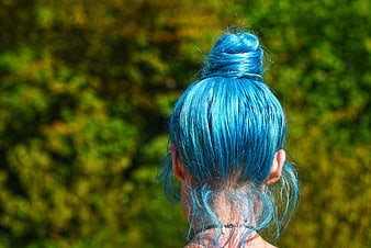 Back view of woman with vibrant blue hair in a bun