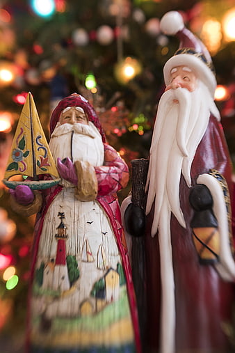Vintage Wooden Santa Claus Figures with Christmas Tree Background