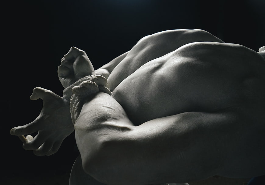 Dramatic Close-Up of Marble Sculpture Torso and Bound Hands