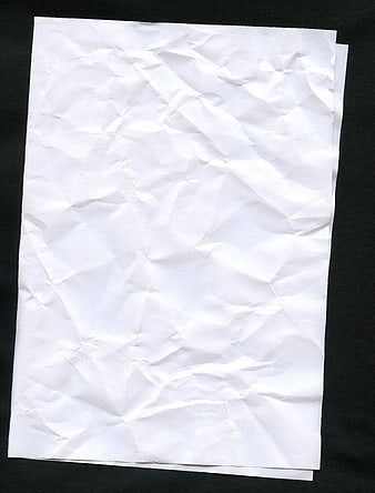 Crumpled white paper texture on black background