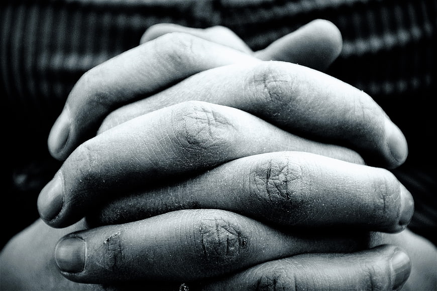 Close-up of clasped hands in black and white
