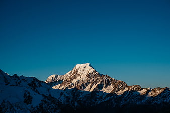 Majestic Snow-Capped Mountain Peak at Sunrise