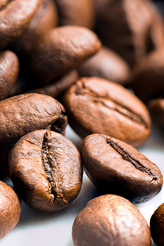 Close-up of roasted coffee beans on white background