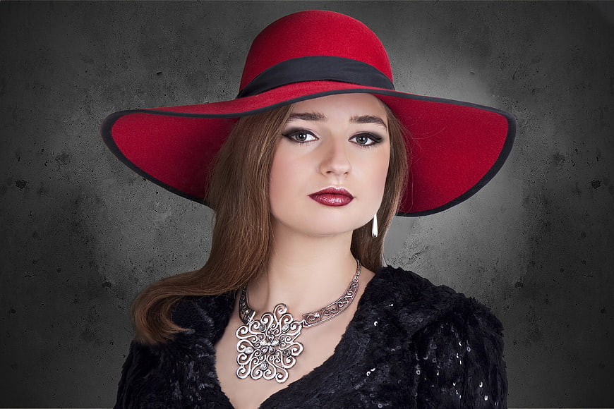 Elegant Woman in Red Hat and Silver Jewelry Portrait