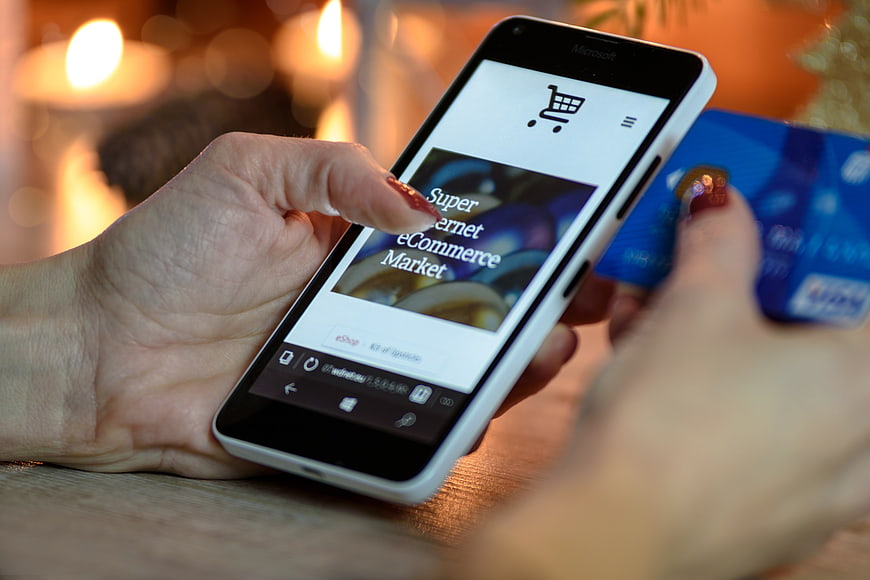 Woman shopping online with smartphone and credit card