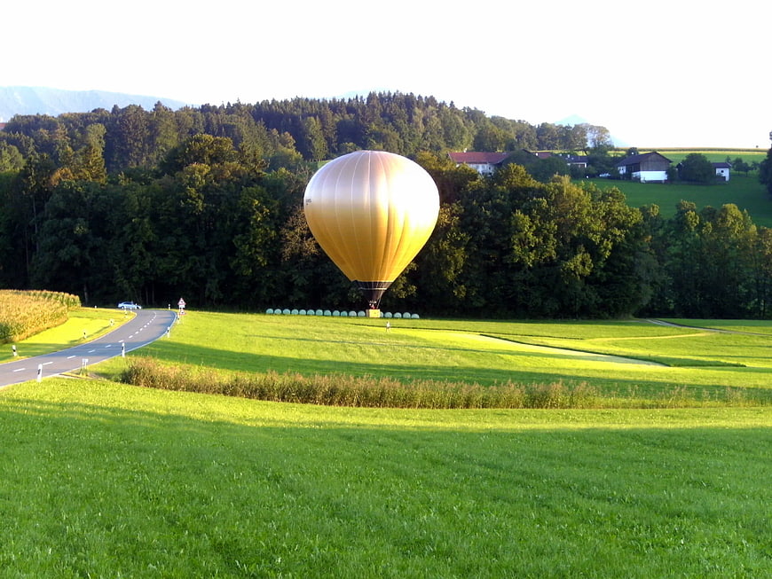 Golden Hot Air Balloon Landing in Green Pastoral Field