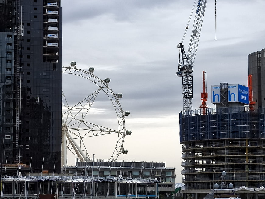 London Eye Ferris Wheel with Construction Cranes and Buildings
