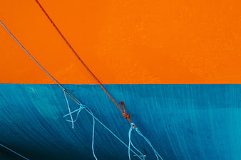 Abstract orange and blue painted wall with ropes
