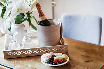 Champagne Bucket with Fruit and Flowers on Wooden Table