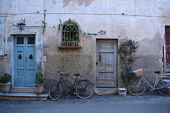 Vintage European Street Scene with Bicycles and Weathered Doors