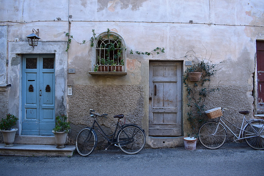 Vintage European Street Scene with Bicycles and Weathered Doors