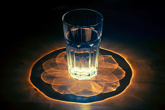 Glass of Water with Intricate Light Refraction Pattern