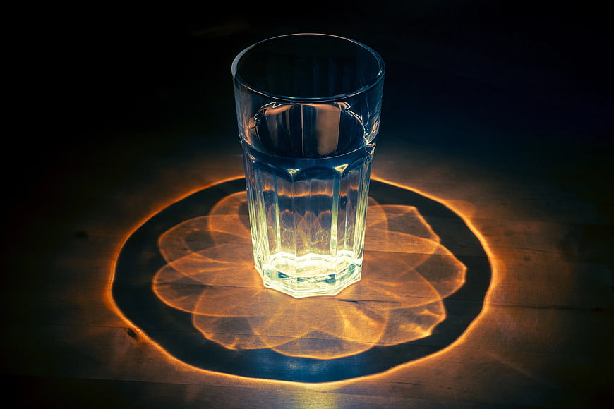 Glass of Water with Intricate Light Refraction Pattern