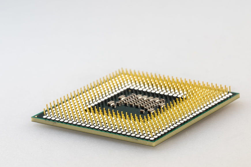 Close-up of CPU Processor with Gold Pins on White Background