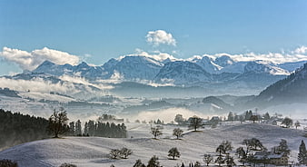 Snowy Mountain Landscape with Misty Valley and Winter Village