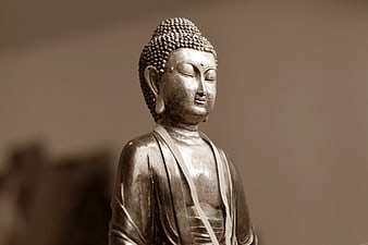 Serene Buddha Statue with Sepia Tone and Soft Focus
