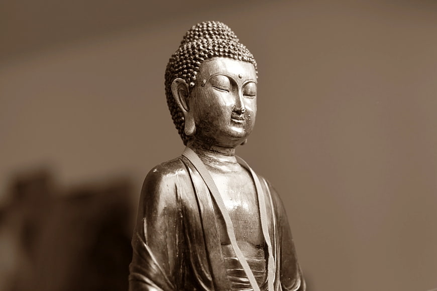Serene Buddha Statue with Sepia Tone and Soft Focus