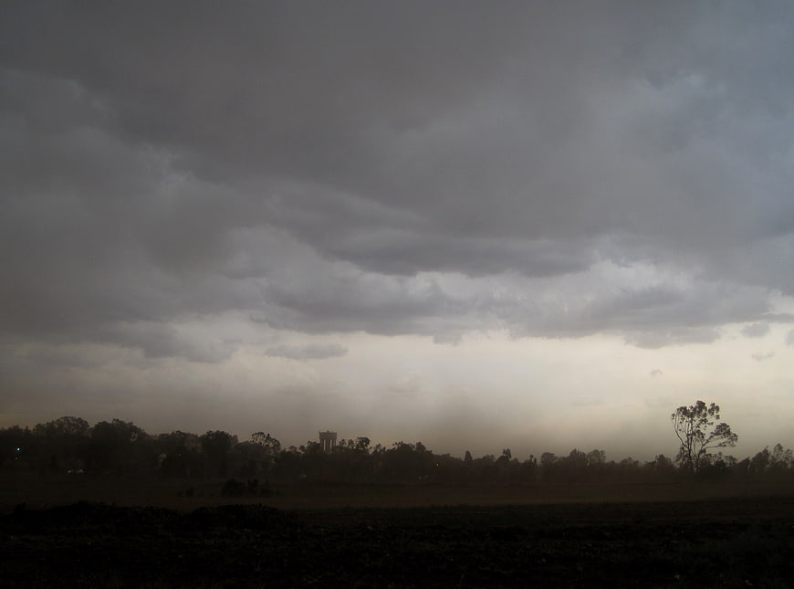 Dark Ominous Storm Clouds Over Rural Landscape