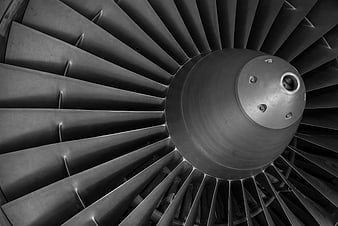 Close-up of a jet engine turbine fan blades in black and white