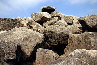 Ancient stone ruins with carved details against blue sky