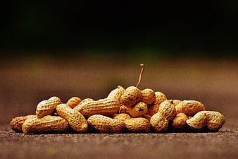 Pile of Raw Peanuts in Shells on Wooden Surface