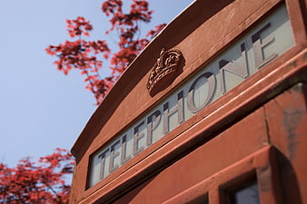 Close-up of red British telephone box with crown emblem