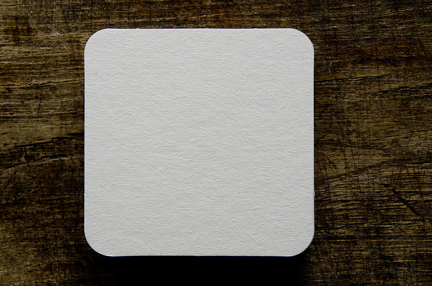 Blank White Coaster on Dark Wood Background