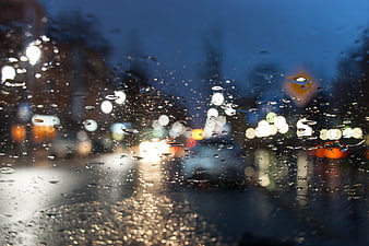 Raindrops on Car Windshield with City Bokeh Lights