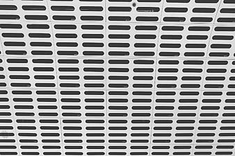 Black and white geometric pattern of pill-shaped slots on metal panels