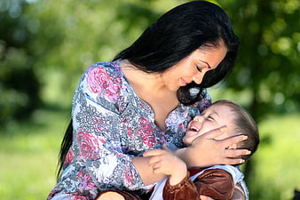 Mother and Baby Laughing Together in a Sunny Park
