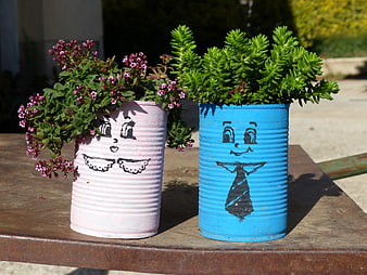 Hand-painted tin can planters with succulents and flowers