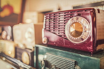 Vintage Maroon Radio on Stack of Retro Radios