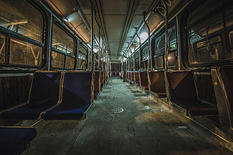 Empty subway car interior with blue seats and gritty atmosphere