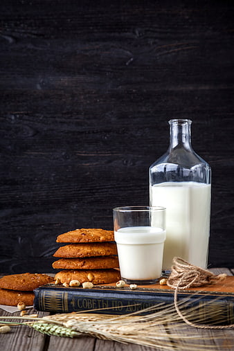 Glass Bottle of Milk and Cookies on Vintage Book