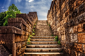 Ancient Stone Staircase Leading Up Between Weathered Masonry Walls