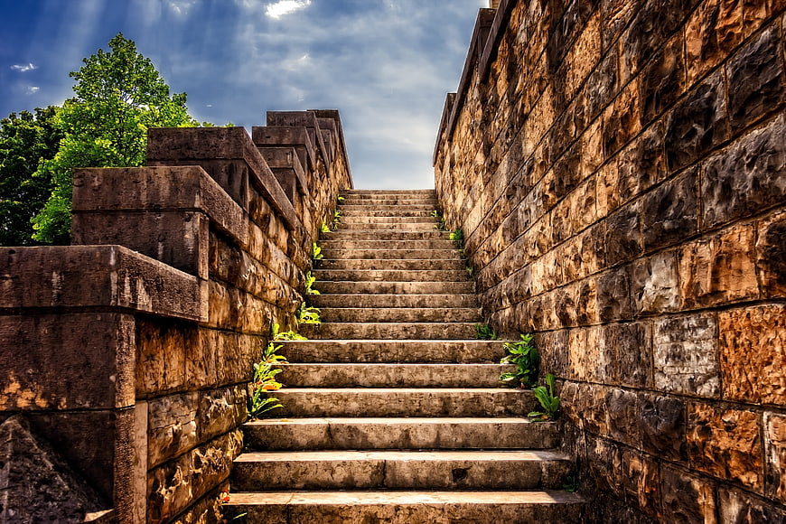 Ancient Stone Staircase Leading Up Between Weathered Masonry Walls