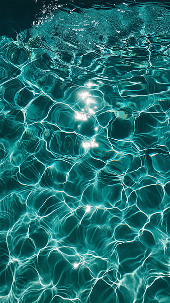 Sunlight Ripples on Turquoise Pool Water Surface