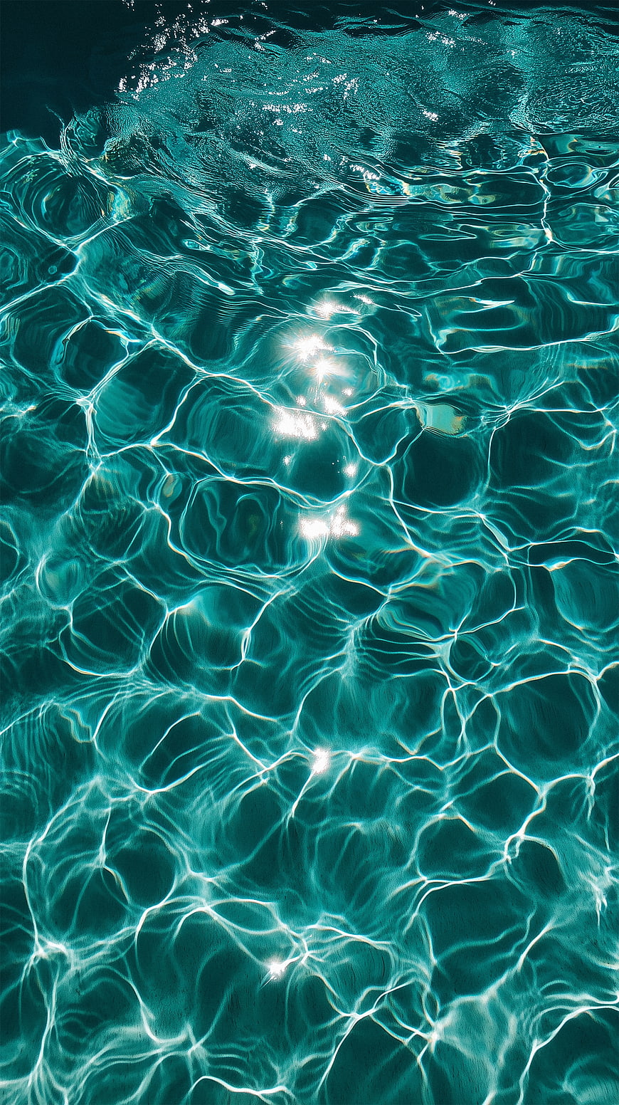 Sunlight Ripples on Turquoise Pool Water Surface
