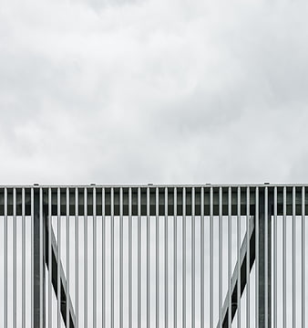 Minimalist Metal Fence Against Overcast Sky