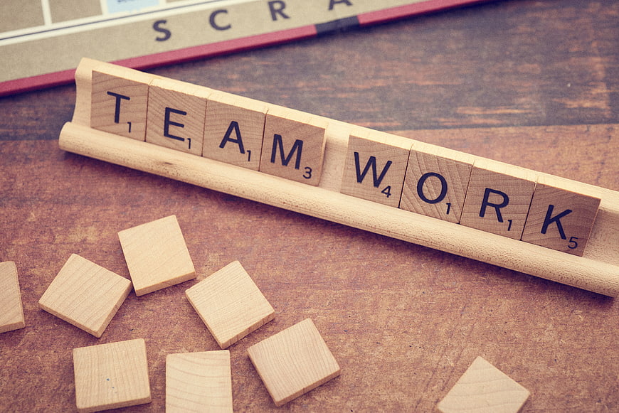 Teamwork Concept with Wooden Scrabble Tiles on Table