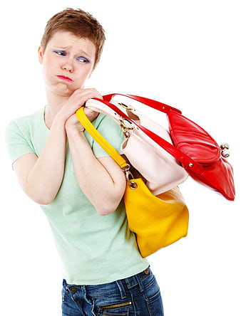 Young woman carrying multiple colorful handbags with a tired expression