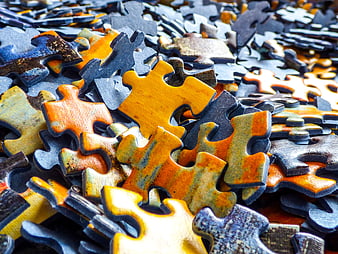 Close-up of scattered wooden jigsaw puzzle pieces