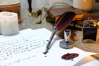 Vintage quill pen, ink, and wax seal on handwritten letter