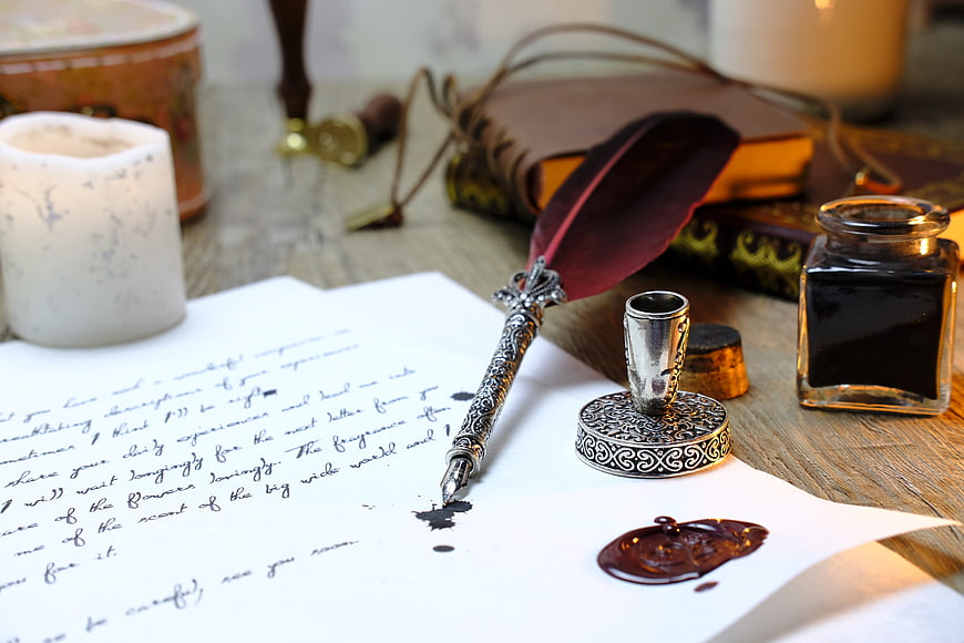 Vintage quill pen, ink, and wax seal on handwritten letter